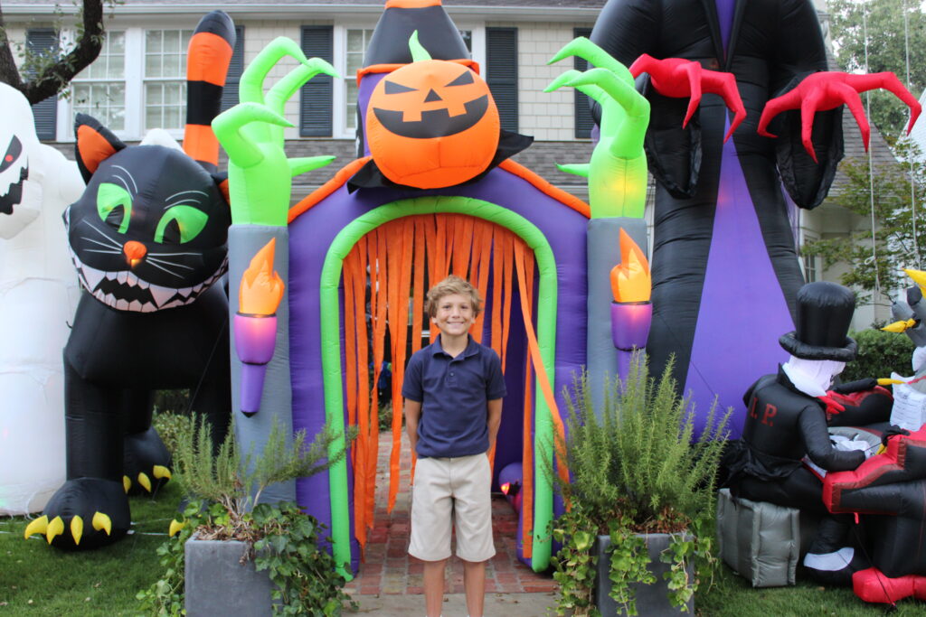 Boy in a Halloween decorated lawn